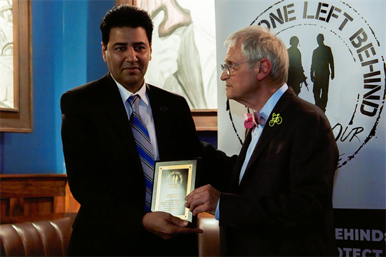 Blumenauer accepting a lifetime achievement award from No One Left Behind